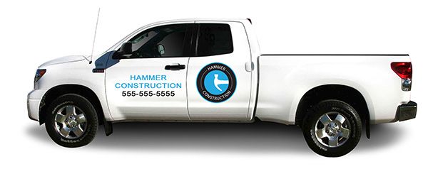 Hammer Construction custom truck decal with the business phone number on white a truck.